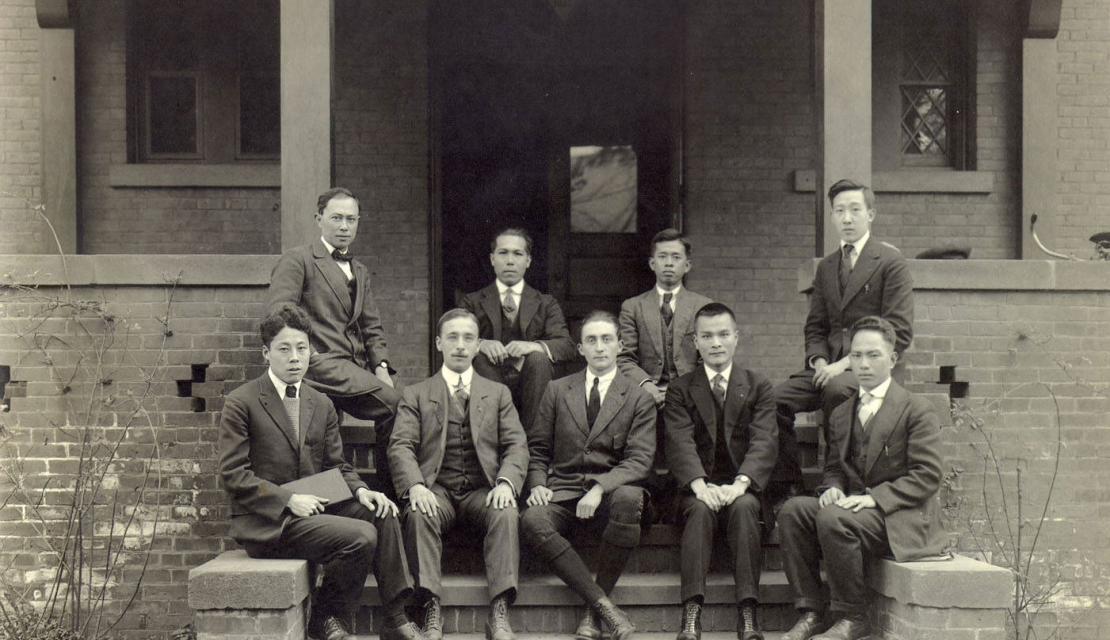 A group of international students sit on the steps of a building at Springfield College in the 1920s.