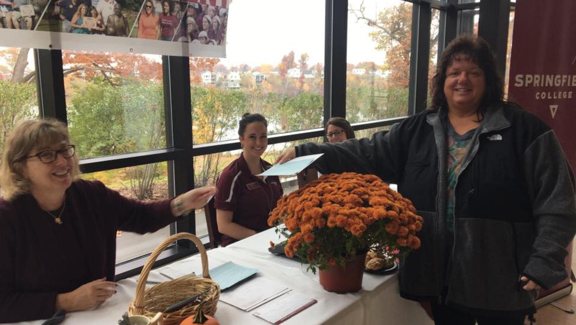 A Springfield College staff member makes a suggestion at the referral table during the day of recruitment.