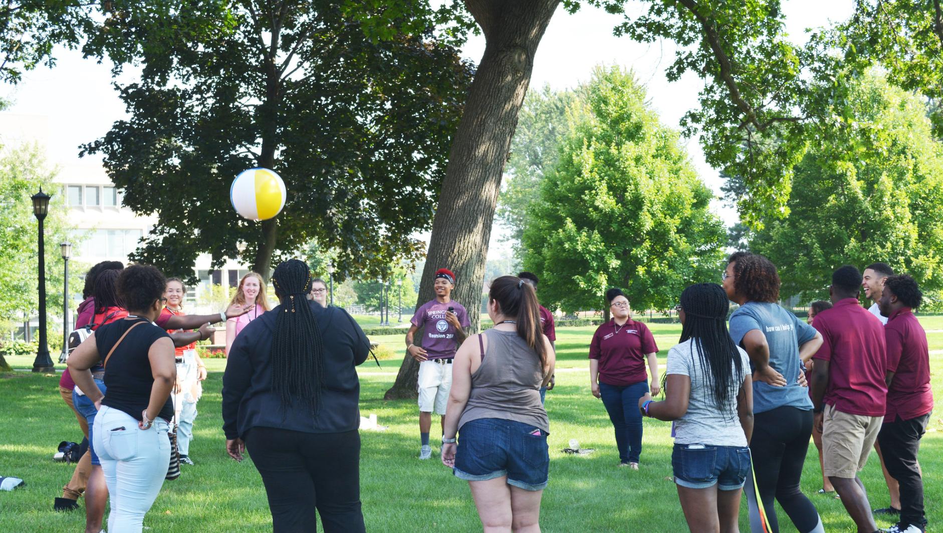 Cultural Connections group plays with a beachball on Naismith Green as part of Orientation