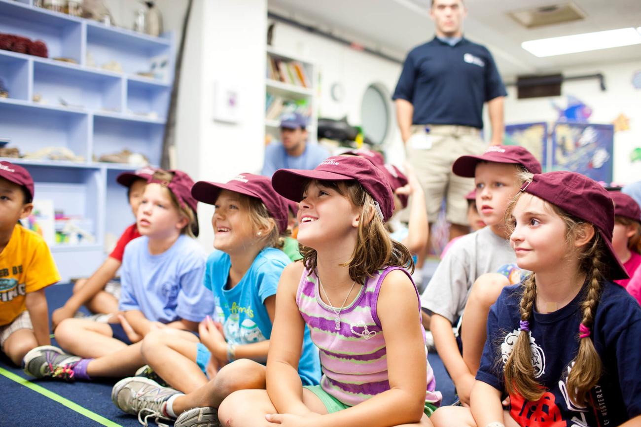 Students sitting in a classroom learning about sea life.