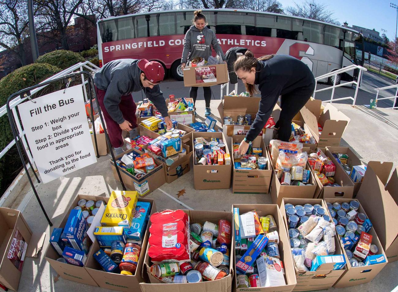 The Springfield College campus community filled the Springfield College Athletics bus on Thursday, Nov. 20, with more than 2,900 pounds of non-perishable food items as part of the annual Fill the Bus campaign, sponsored by the Springfield College Student Athlete Leadership Team (S.A.L.T.), the Department of Public Safety, and the Division of Inclusion and Community Engagement.