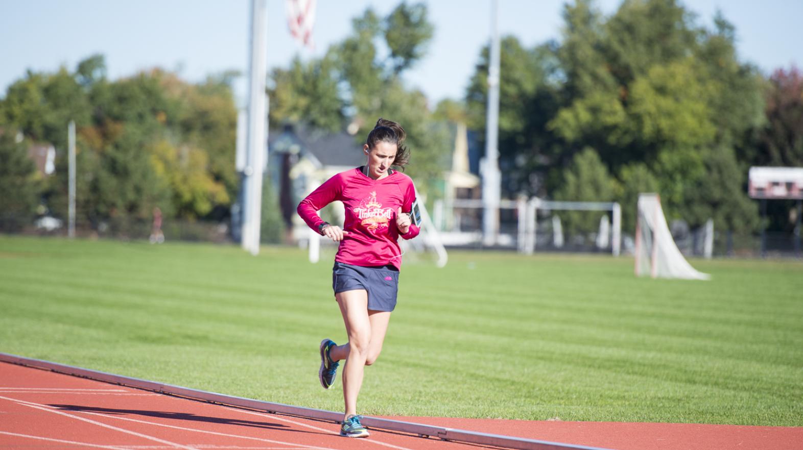 A student runs on Blake Track
