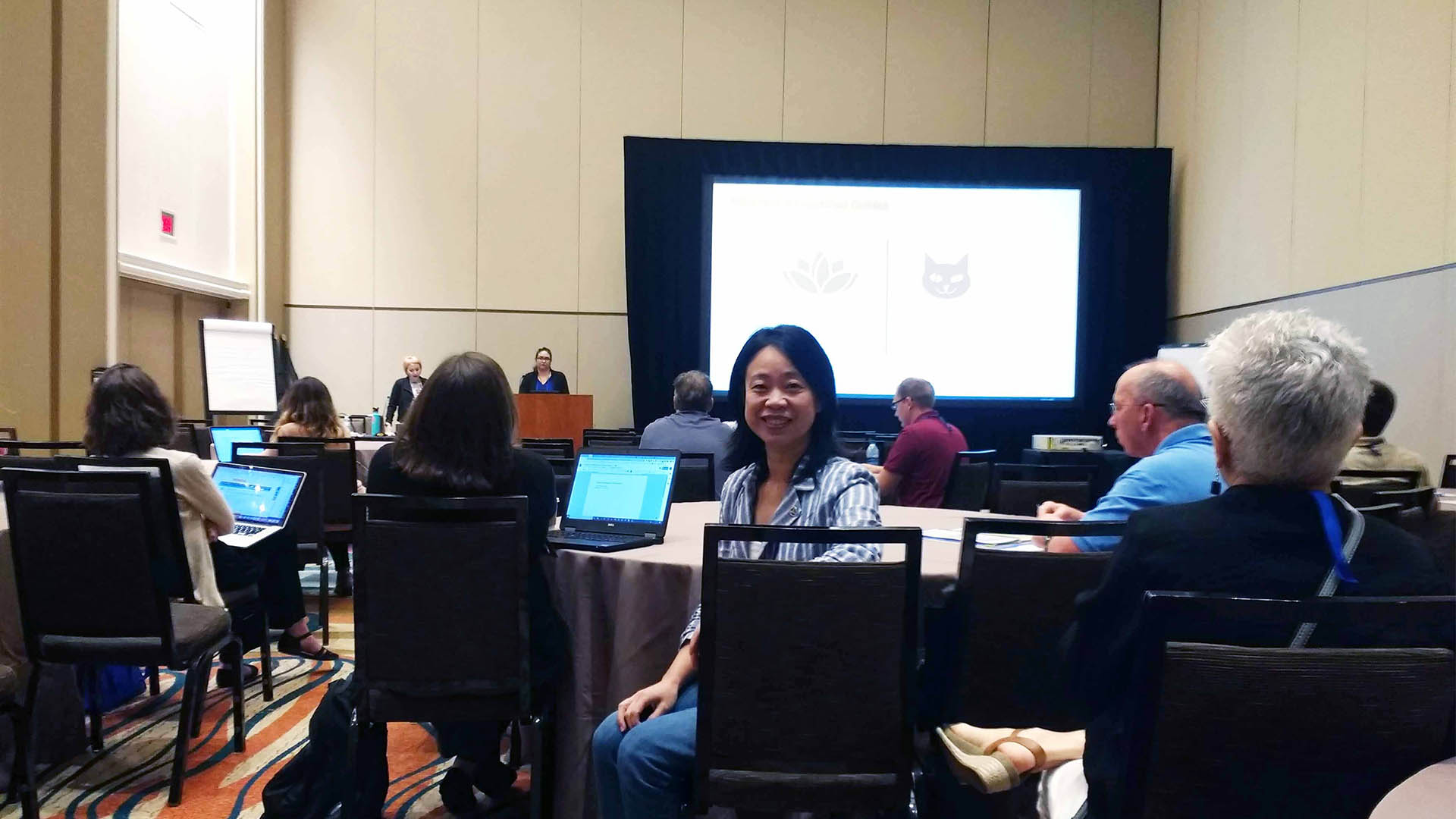 Li Jin sits at a table during a conference meeting. 