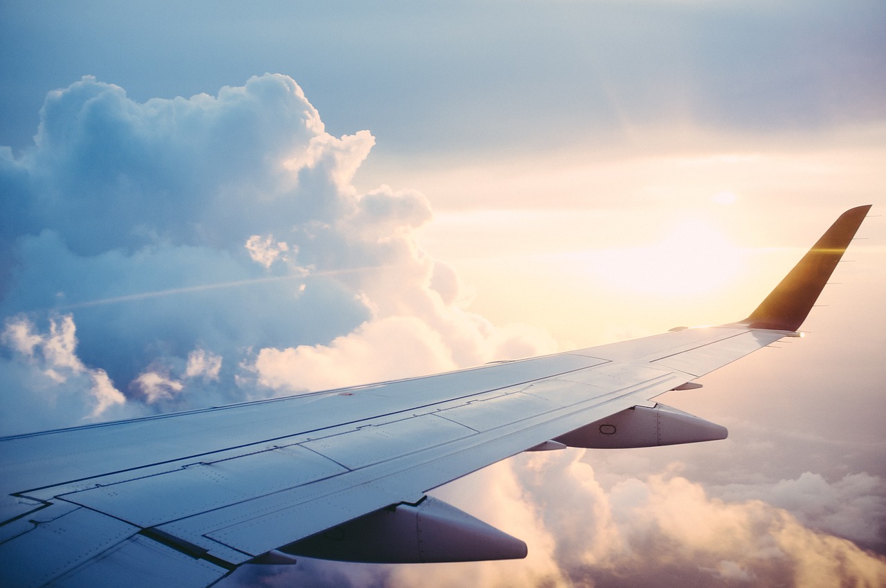 The wing of an airplane midflight. 