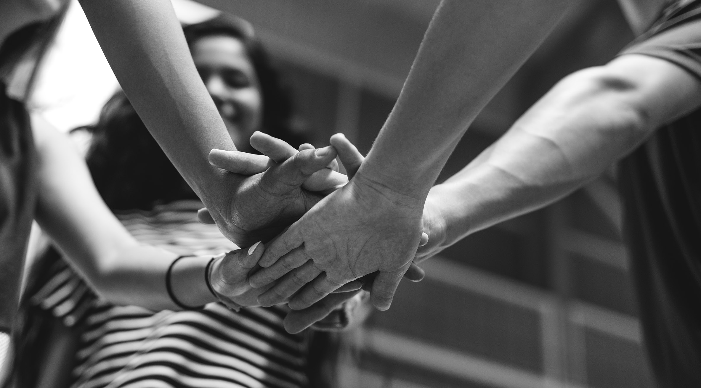 Students with their hands together. 