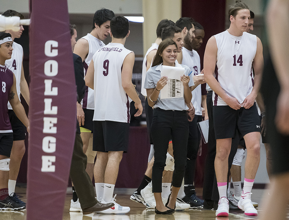 A coach discusses strategy with her team