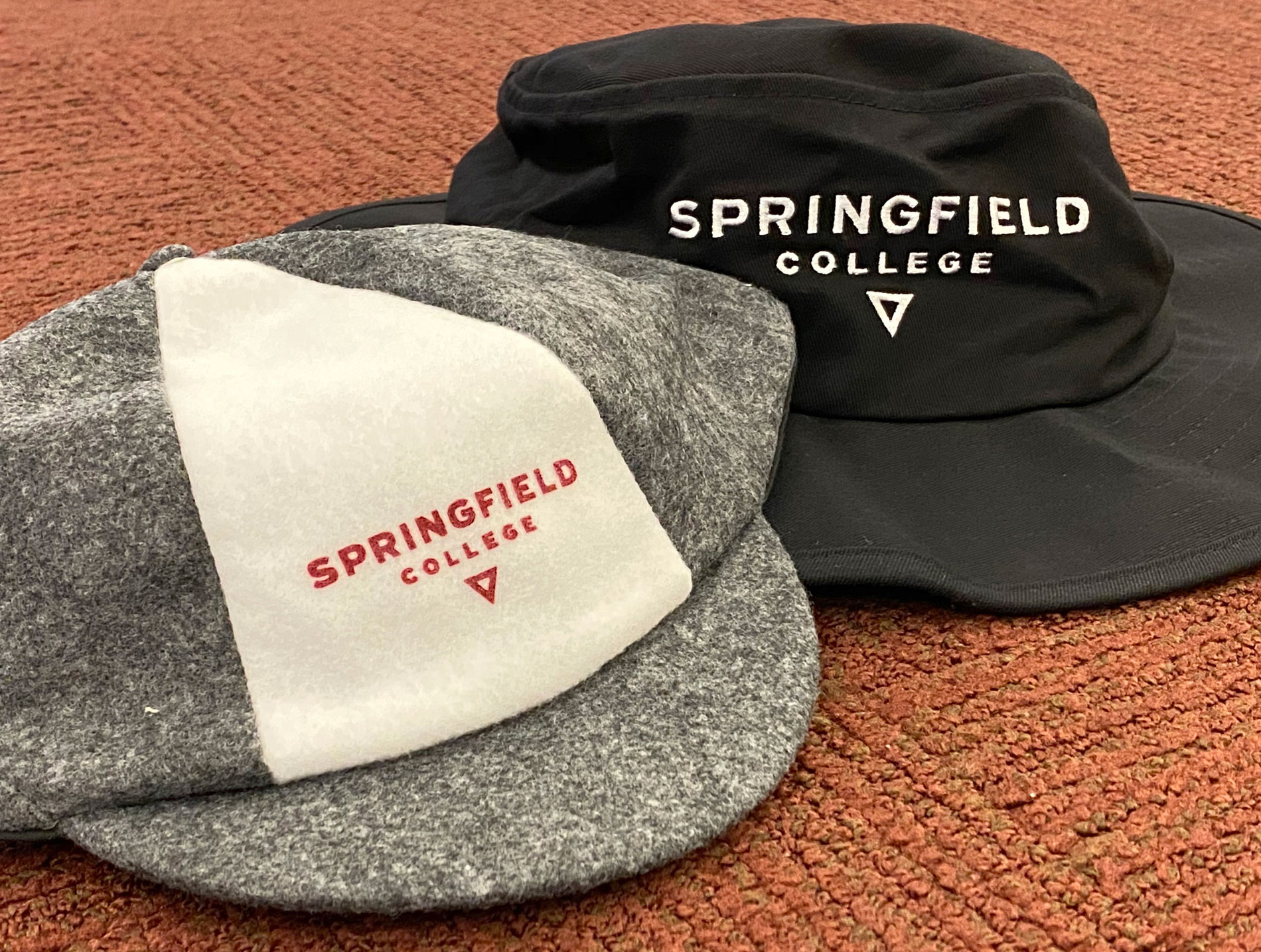 An image of the Springfield College beanie and transfer bucket hat