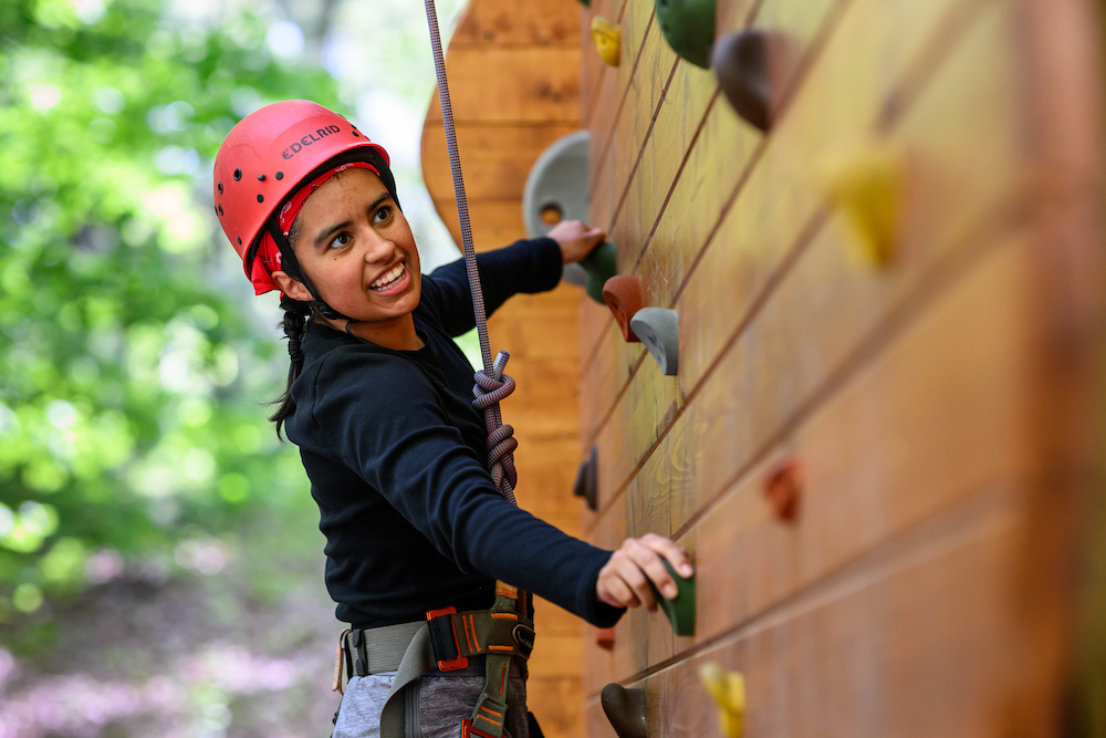 Female student climbing wall at East Campus