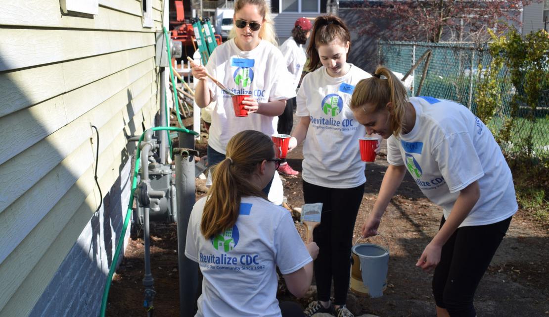Students help fix up a downtown home as part of revitalization. 