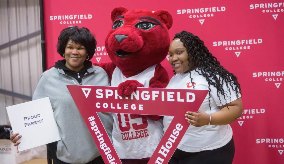 An incoming student and her mother pose with the mascot at Accepted Student Open House. 