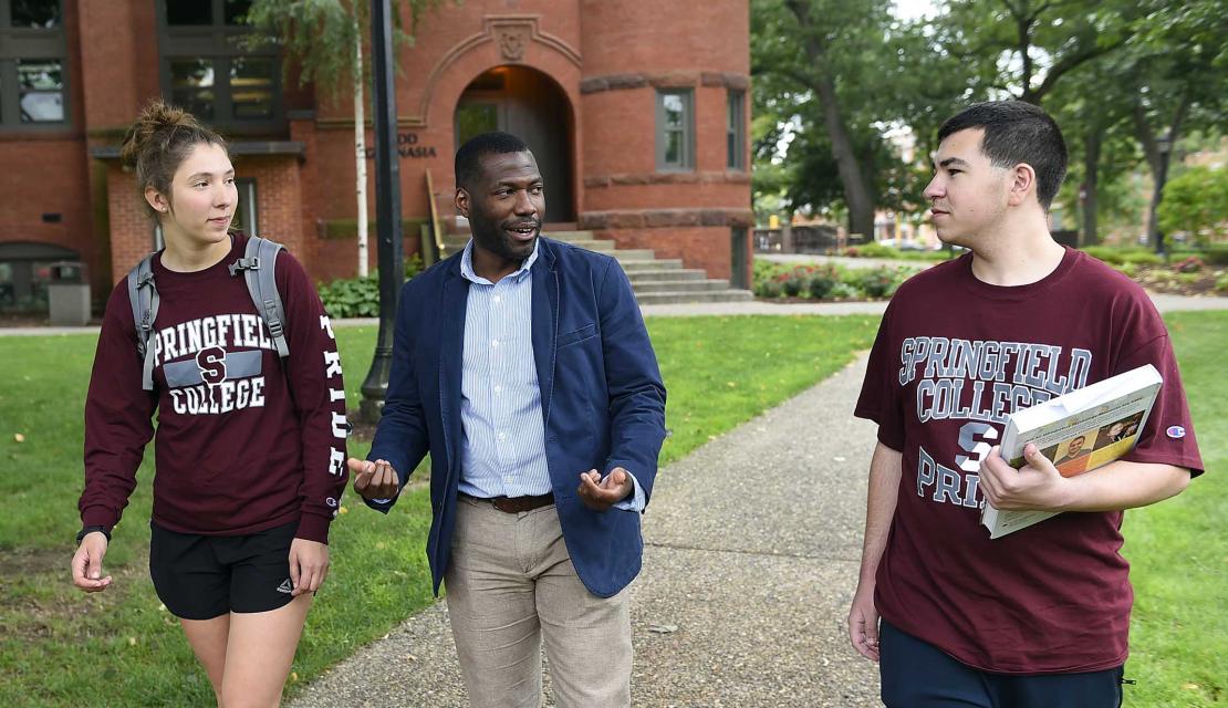 Students and a professor walking on campus