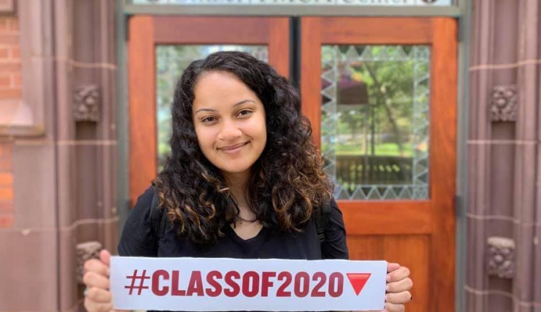 Graciela holds up a class of 2020 sign. 