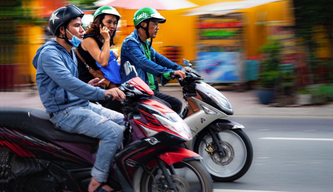 three people riding motorcycles in Vietnam