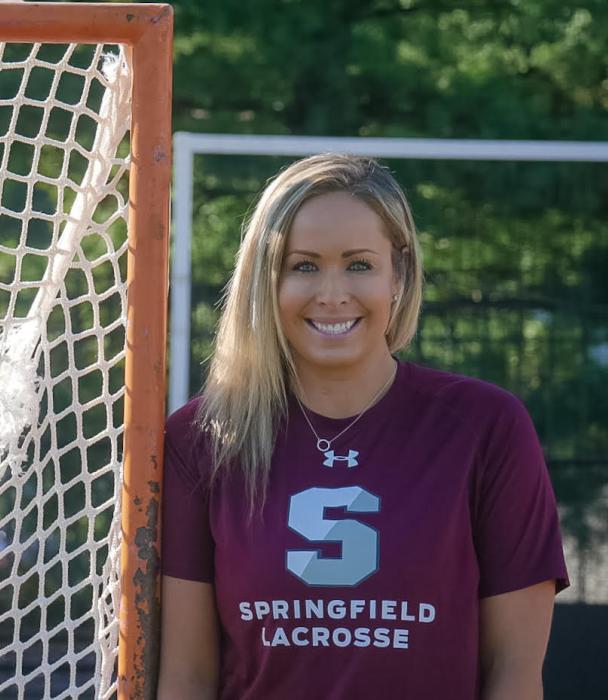 Photo of Jenn Thomas by a lacrosse net