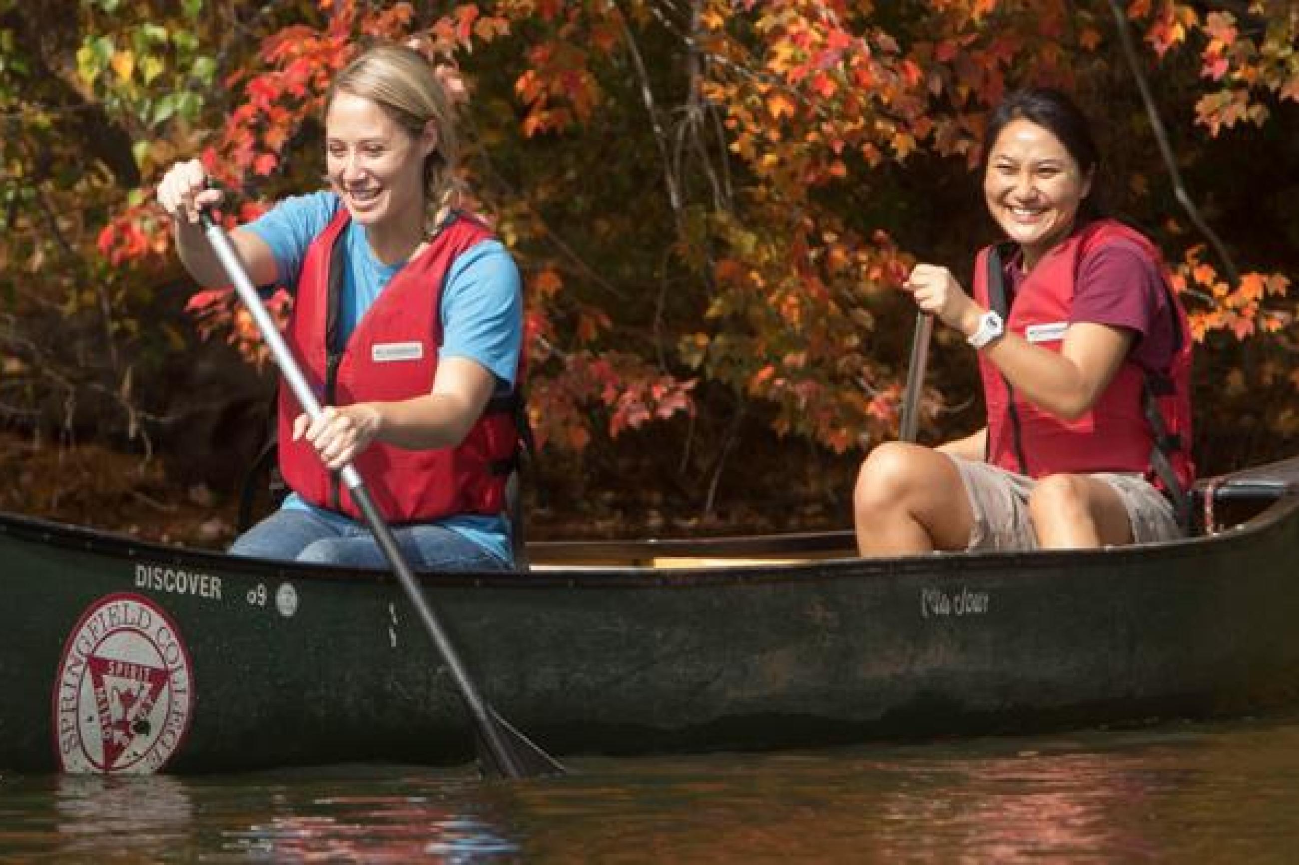 Two female students canoe at east campus