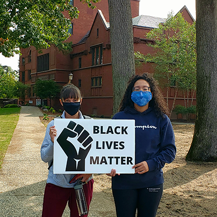 two students holding a Black Lives Matter sign on campus