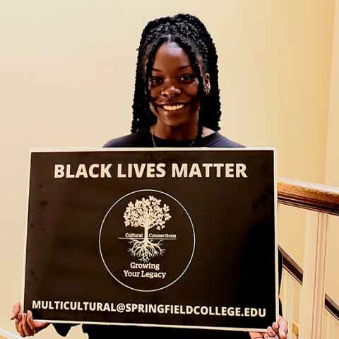 female student holding Black Lives Matter sign