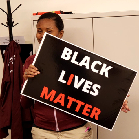 female holding Black Lives Matter sign