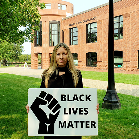 staff member holding Black Lives Matter sign