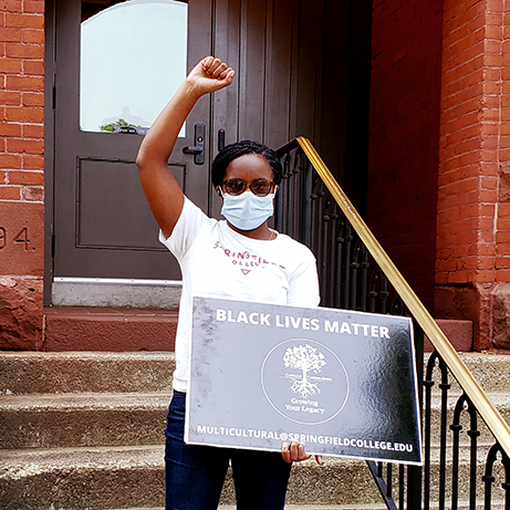 woman with raised fist and BLM sign