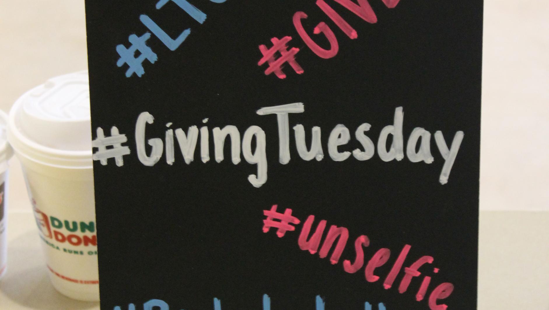 A sign showing hashtags used during the 2015 Giving Tuesday