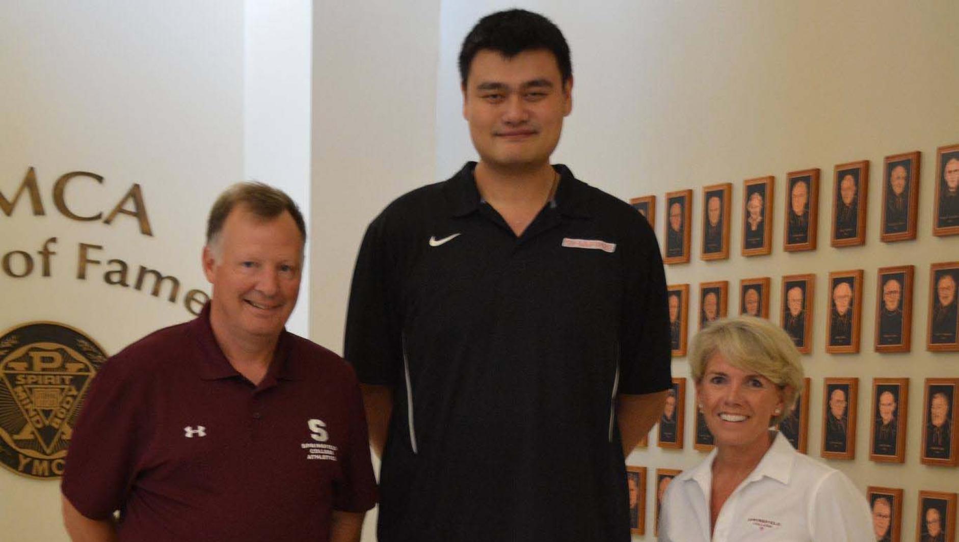 David Cooper, Yao Ming, and Springfield College President Mary-Beth Cooper pose together in the Museum on the College's campus.