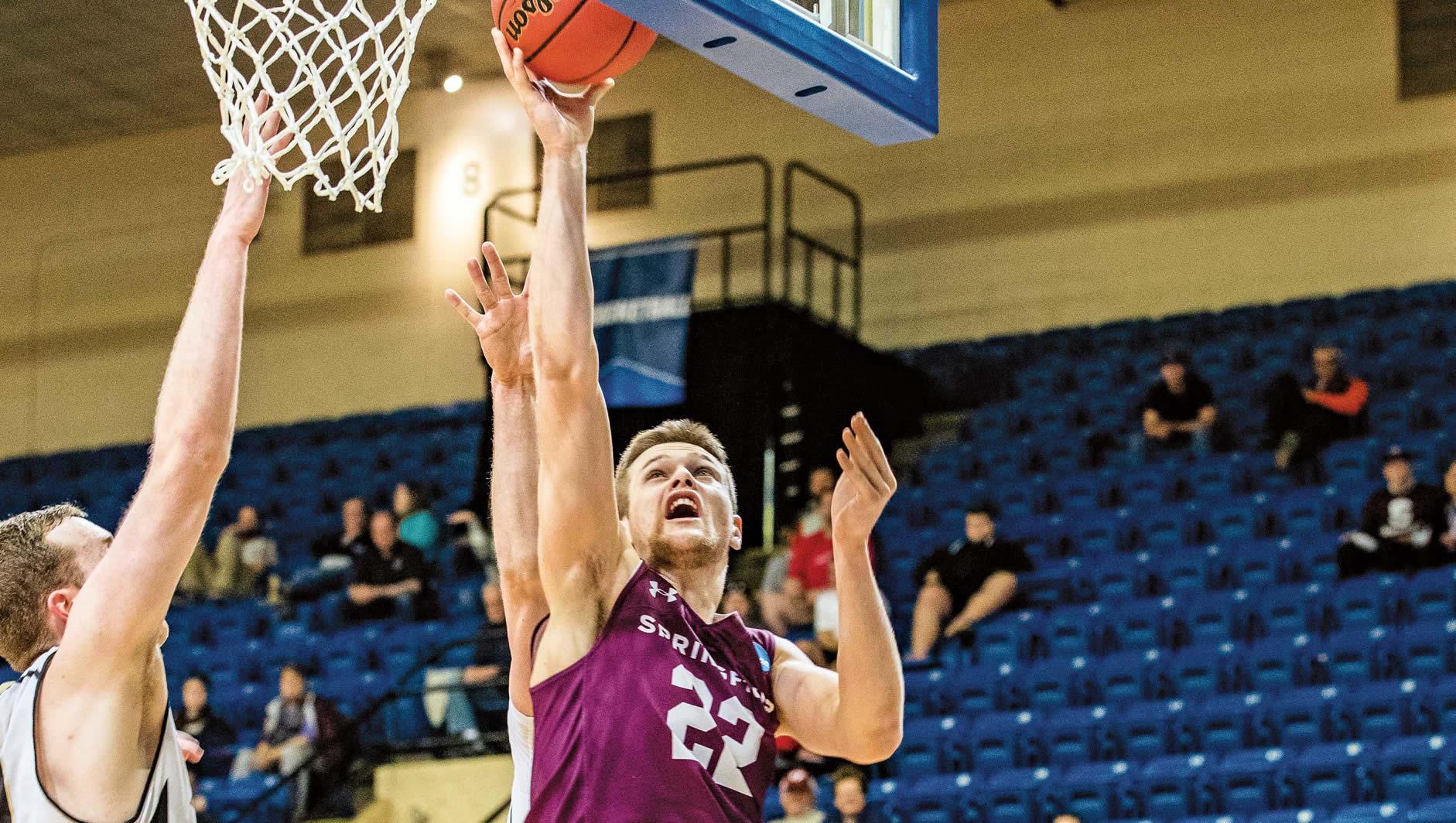 Sophomore Jake Ross (Northampton, Mass.) gets inside two defenders for a layup.