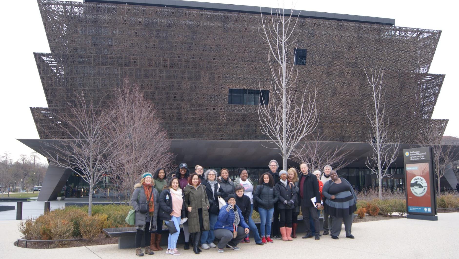 A group of Springfield College students pose outside of the Smithsonian National Museum of African American History and Culture