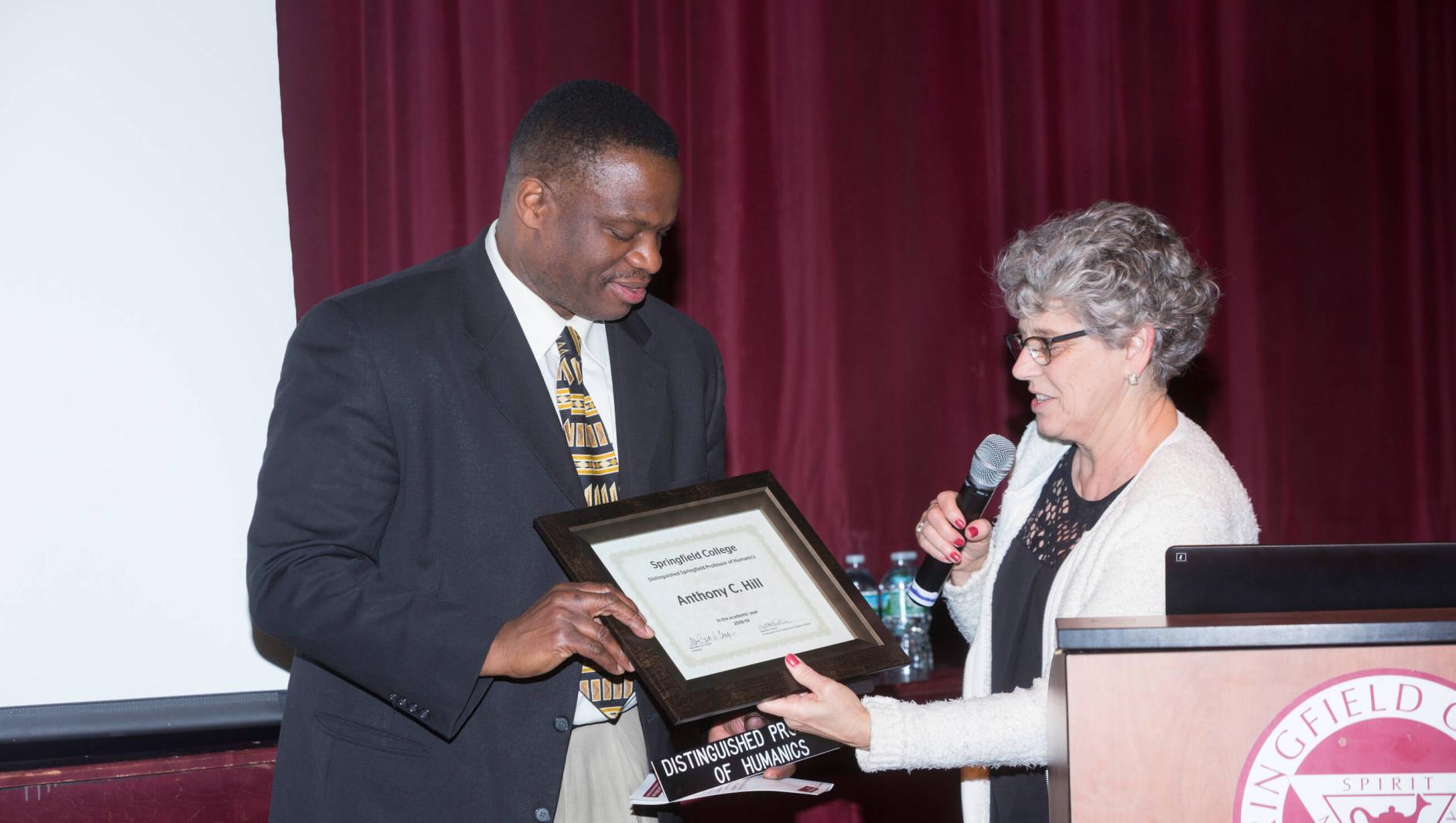 Dr Hill receiving an award. 