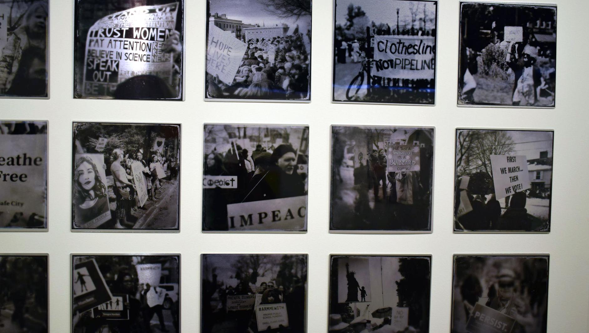 prints of social justice hung in a gallery