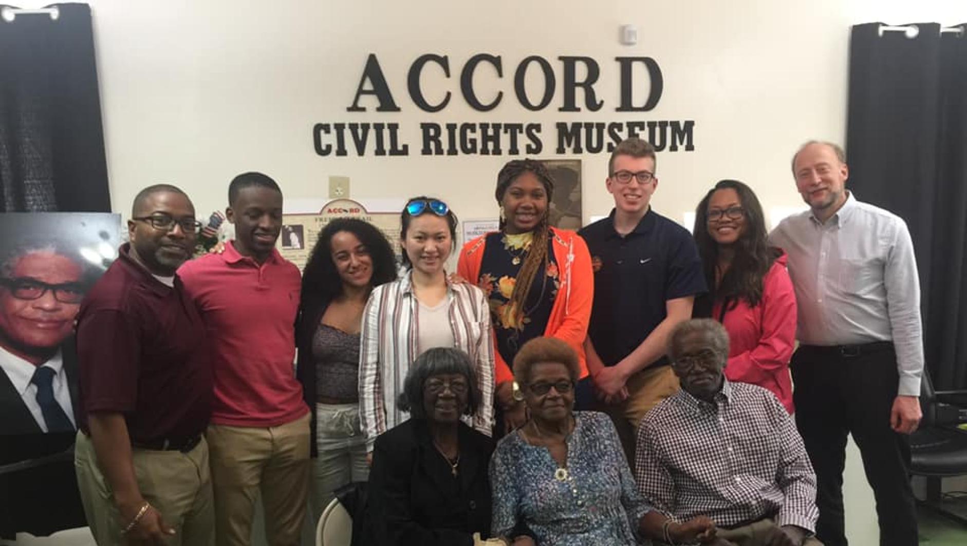 Calvin Hill, Marty Dobrow, and students at the ACCORD Civil Rights Museum. 