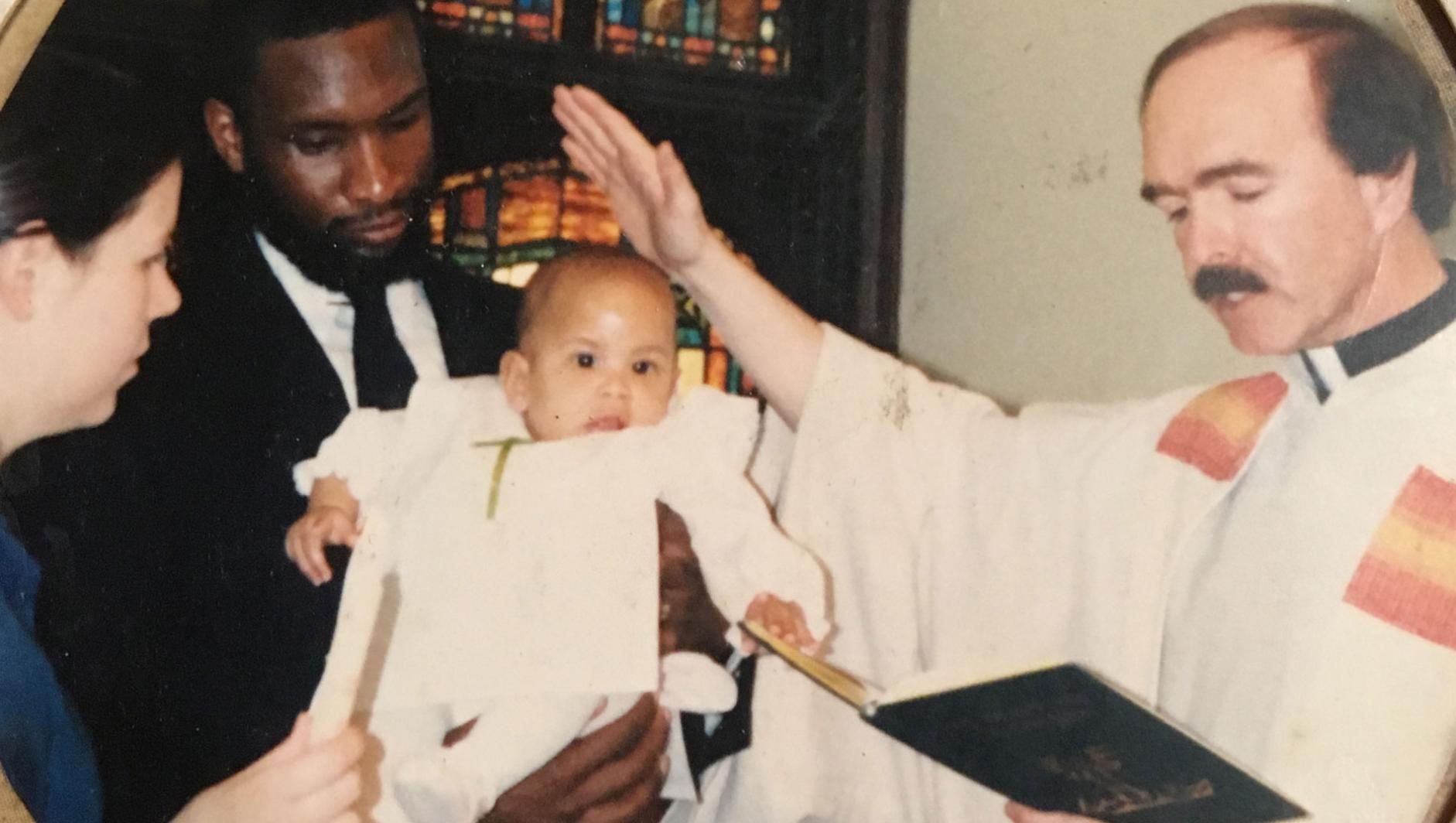 Father Leo baptising a baby