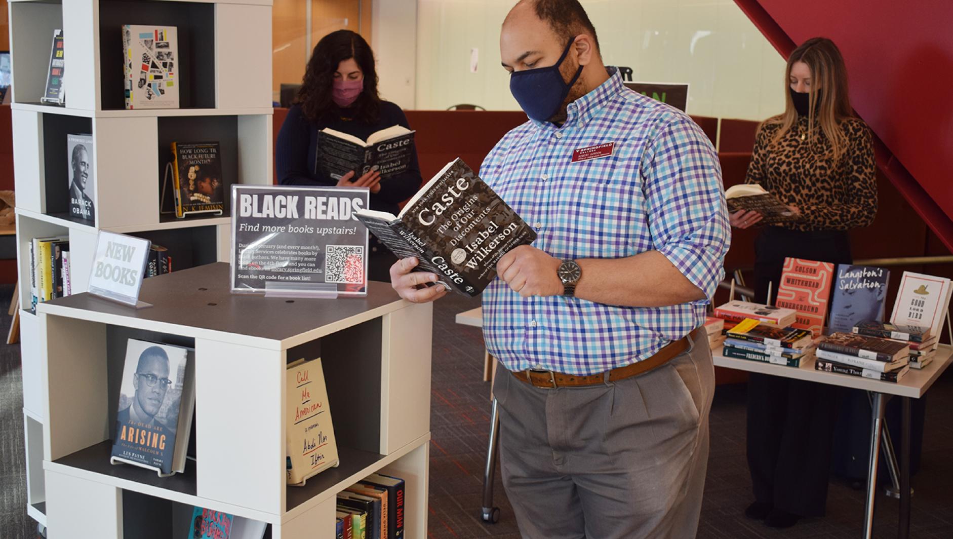 Library staff reading books by Black authors