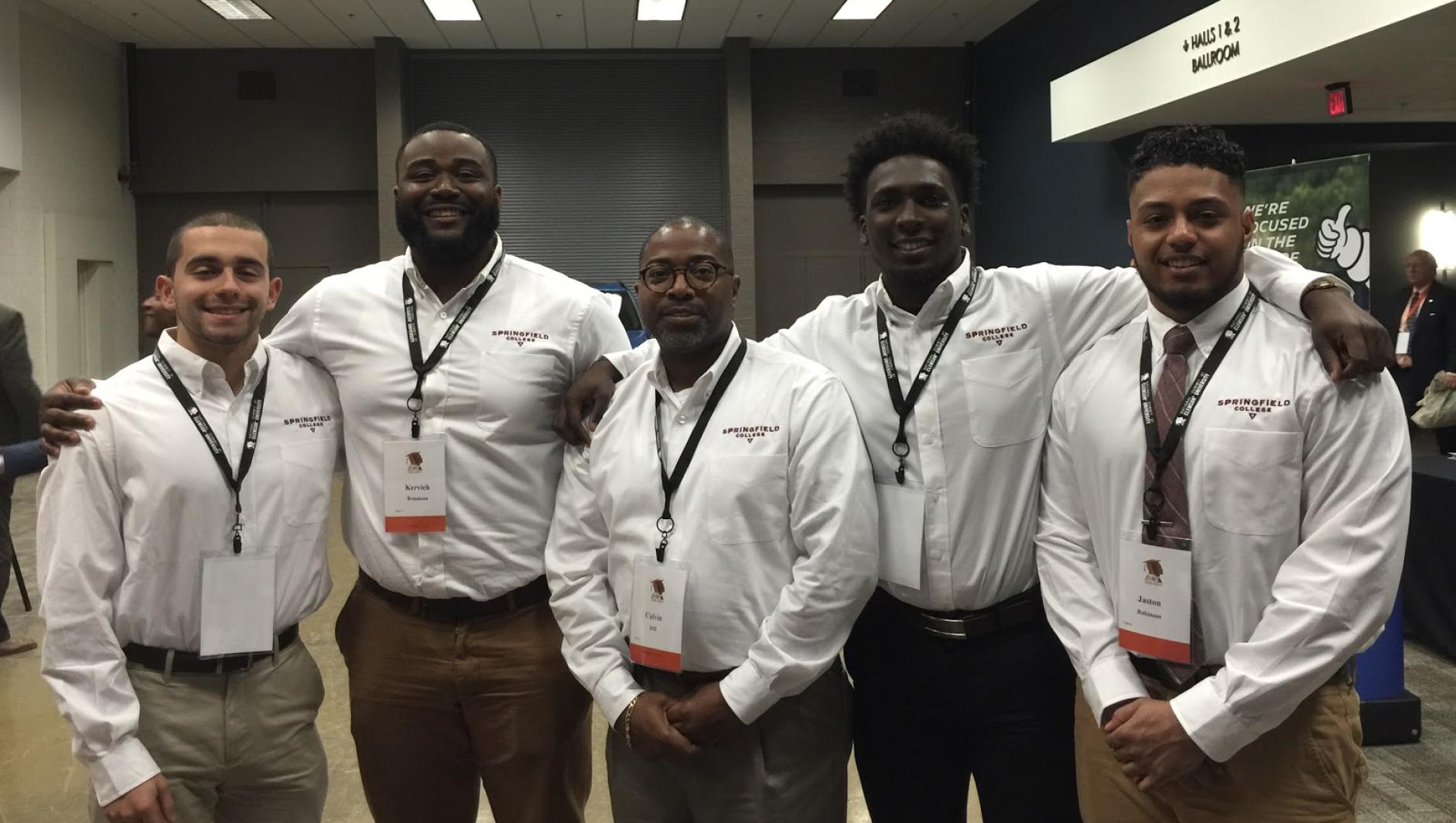 Vice President Calvin Hill and four students at the Men of Color Summit in 2017