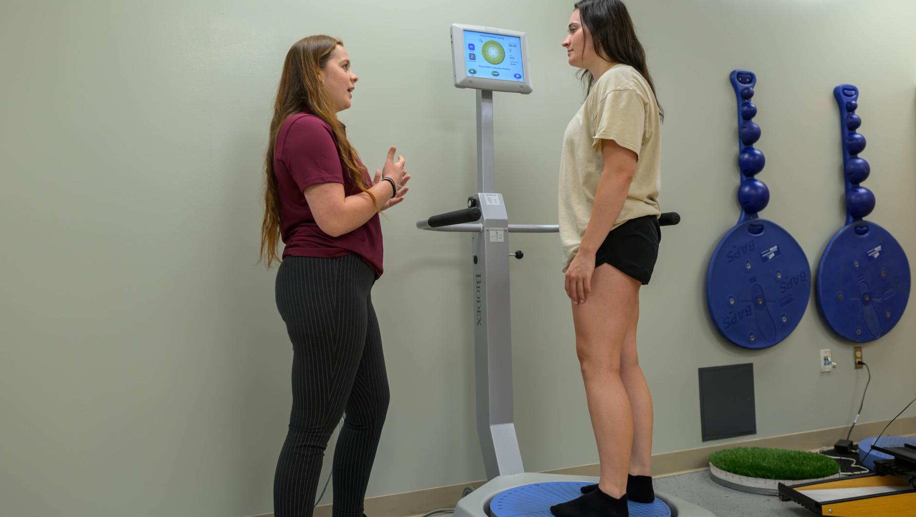 Springfield College Athletic Training students and faculty work with BioDex balance test equipment in the rehabilitation room on May 29, 2024.