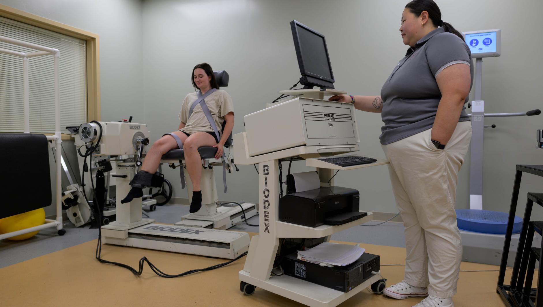 Springfield College Athletic Training students and faculty work with BioDex isokinetic strength analyzer equipment in the rehabilitation room on May 29, 2024.