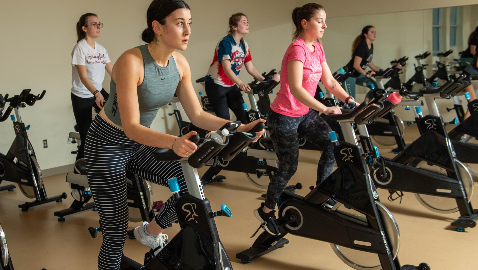 Springfield College students workout during a spin class in the Wellness Center on Thursday, March 10, 2022.