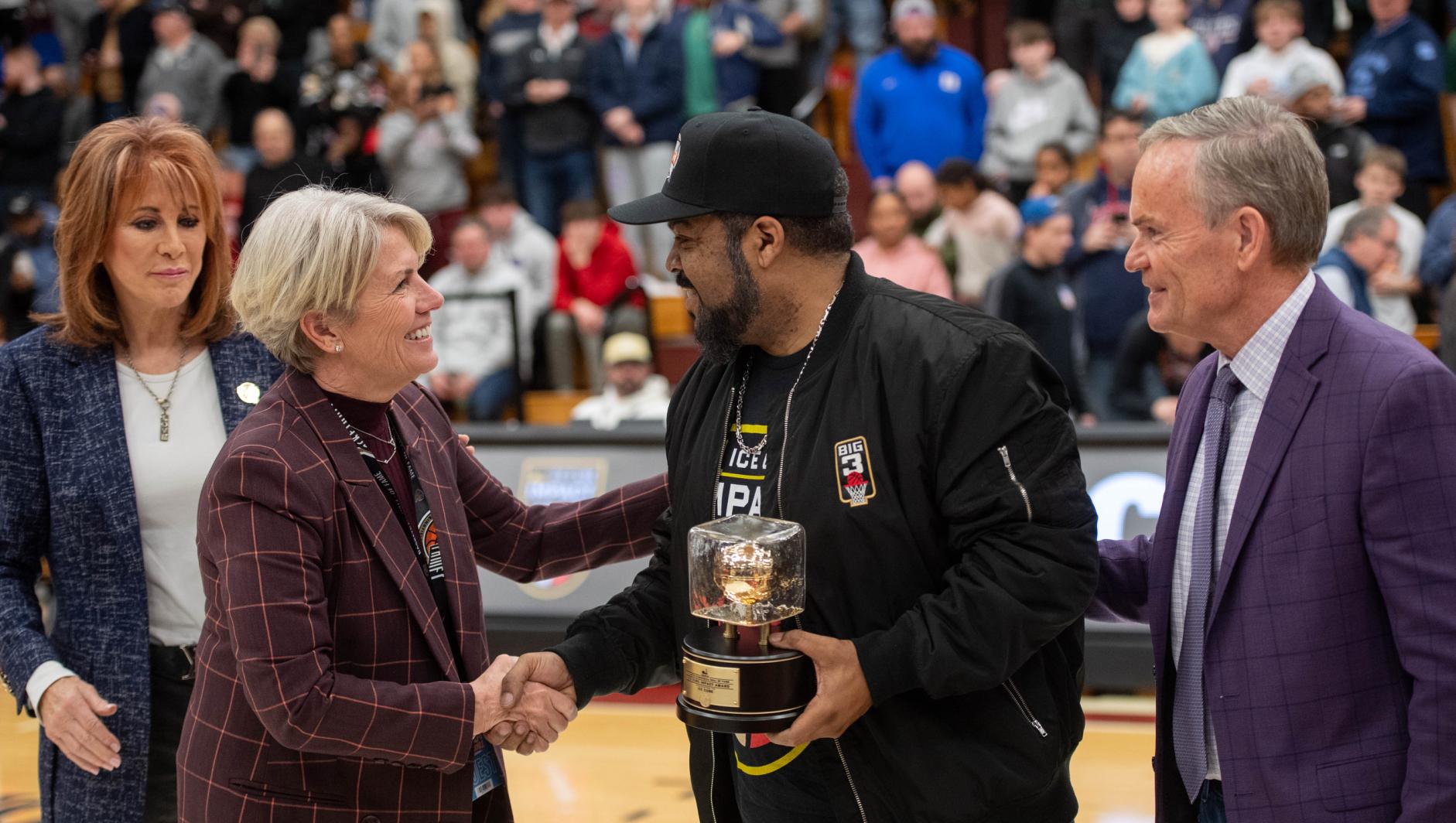 Mary-Beth Cooper, President of Springfield College, congratulates Rapper, actor and film producer Ice Cube receives the Naismith Memorial Basketball Hall of Fame Ice Cube Impact Award during the Spalding Hoophall Classic 