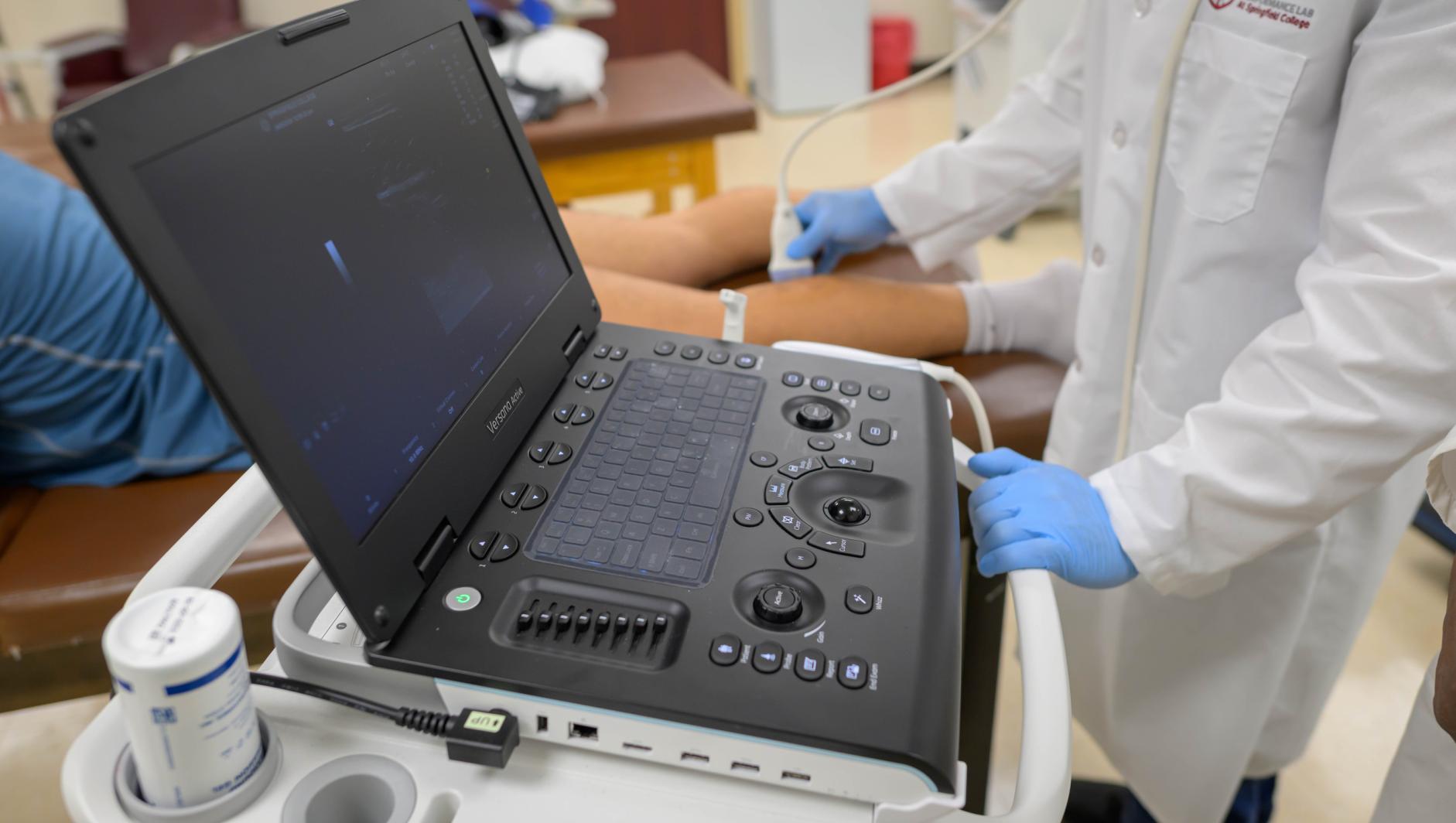 Springfield College exercise physiology graduate student Christopher Mette, left, and Professor of Exercise Science Samuel A.E. Headley work with diagnostic ultrasound machine