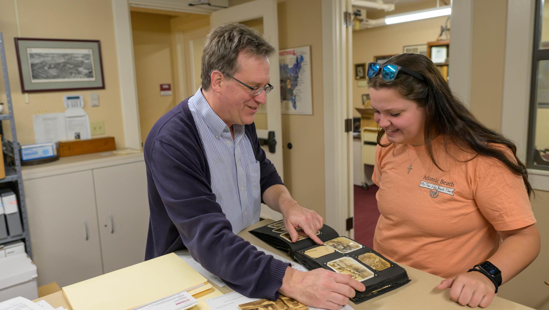 College Archivist Jeffery Moneau works with students at the Springfield College Archives located inside Judd Gymnasia 