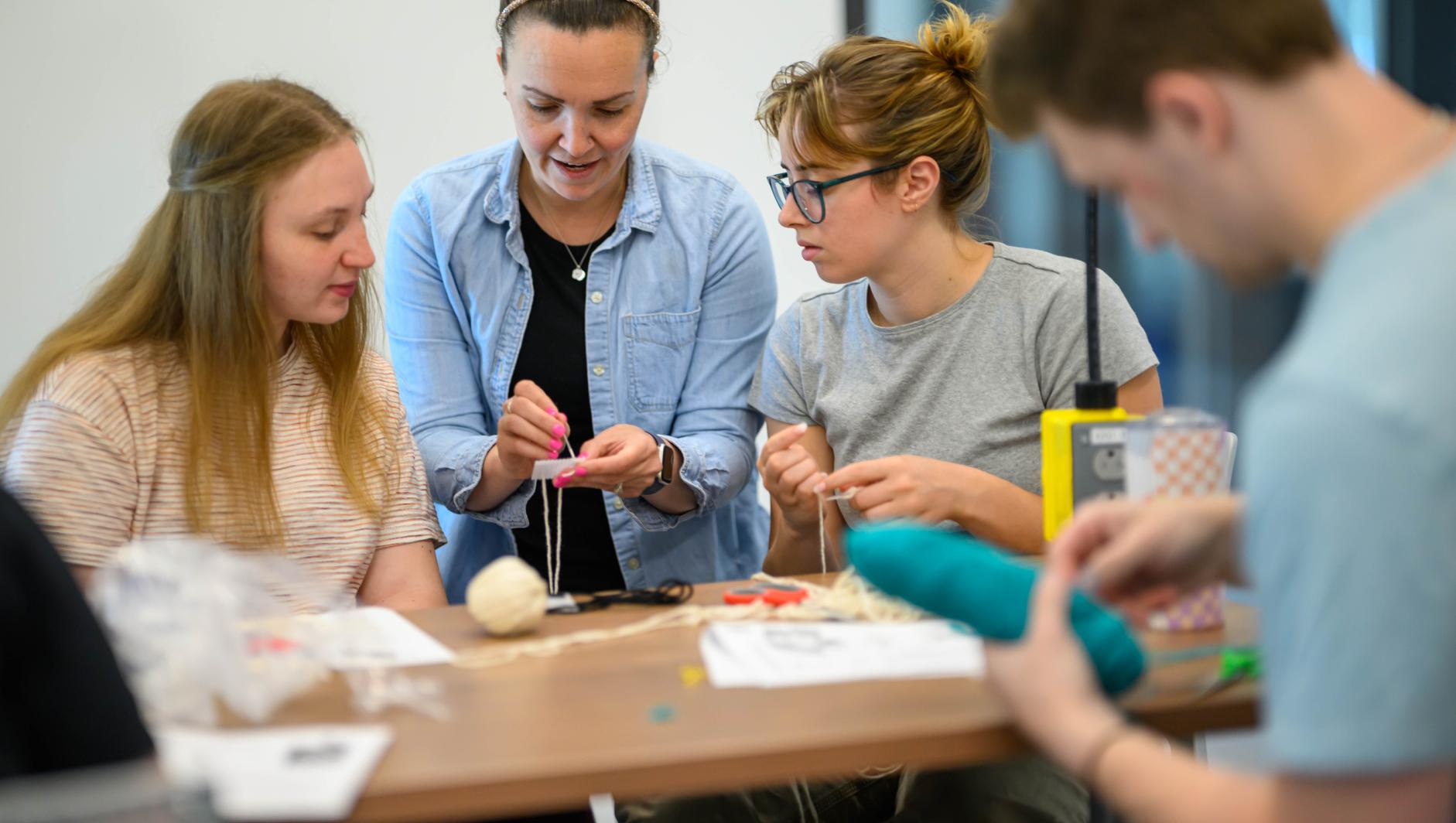Amanda Rodriguez, assistant professor of occupational therapy, works with Springfield College Occupational Therapy students during a lab inside the Health Sciences Center