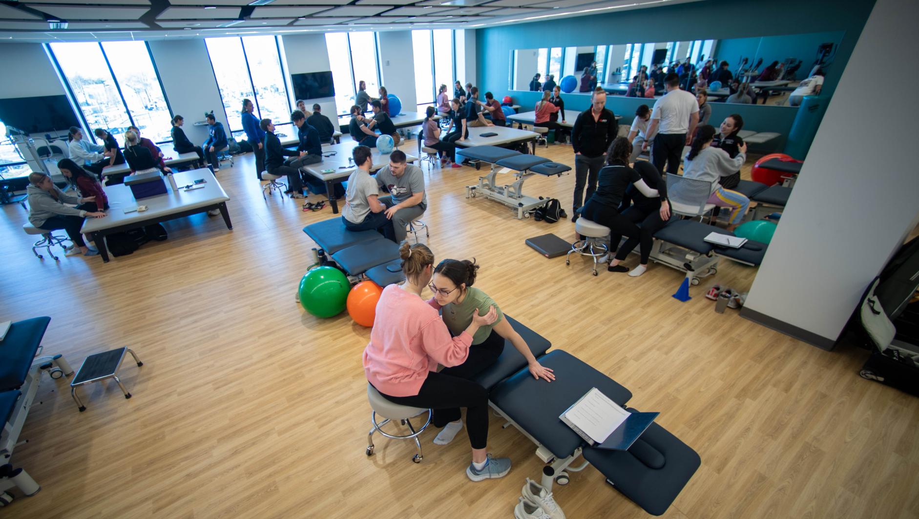 Physical therapy students work with community members during a Community Clinic in the Health Sciences Center at Springfield College on Tuesday, February 6, 2024