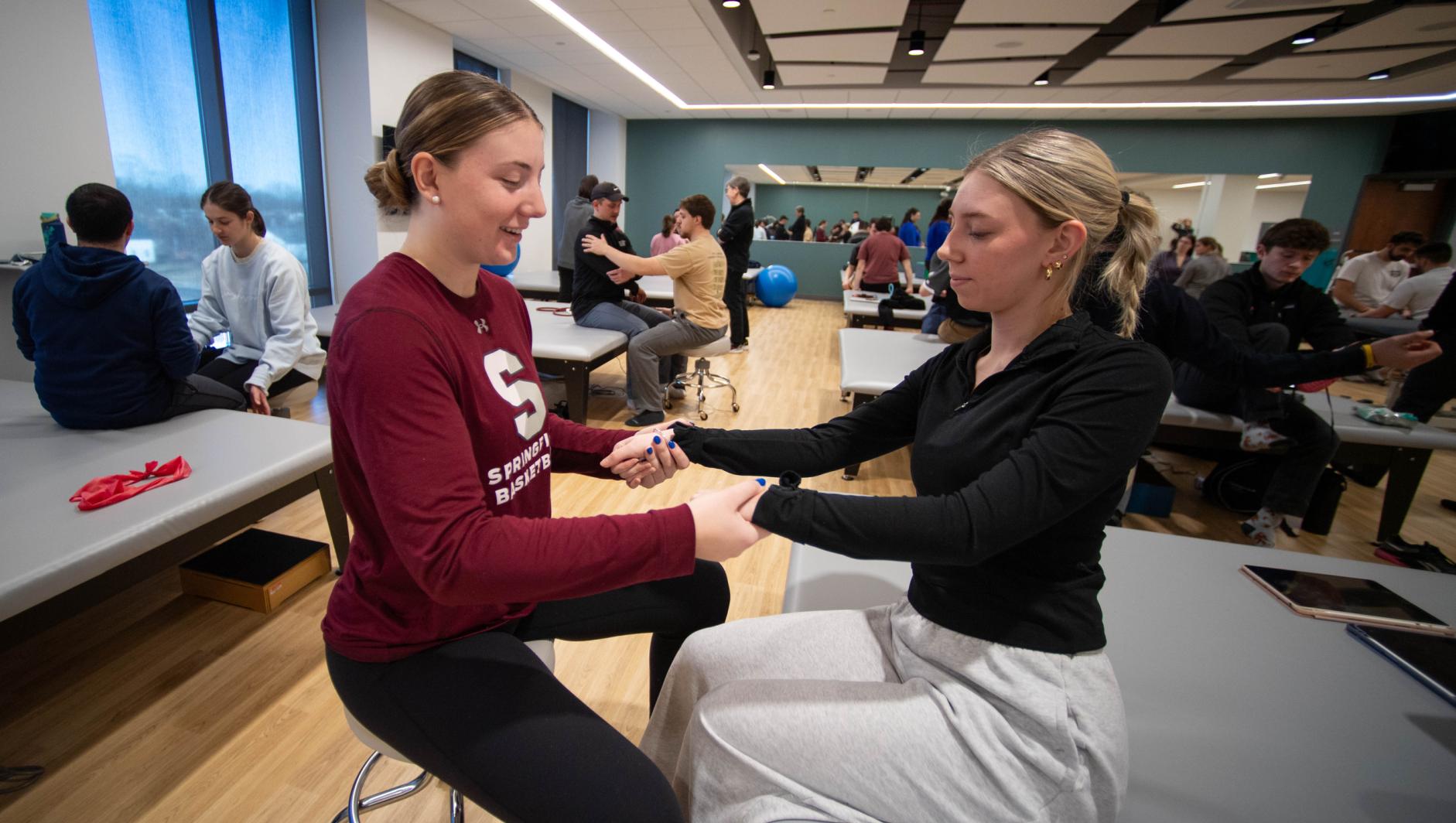 Physical therapy students work with community members during a Community Clinic in the Health Sciences Center at Springfield College on Tuesday, February 6, 2024