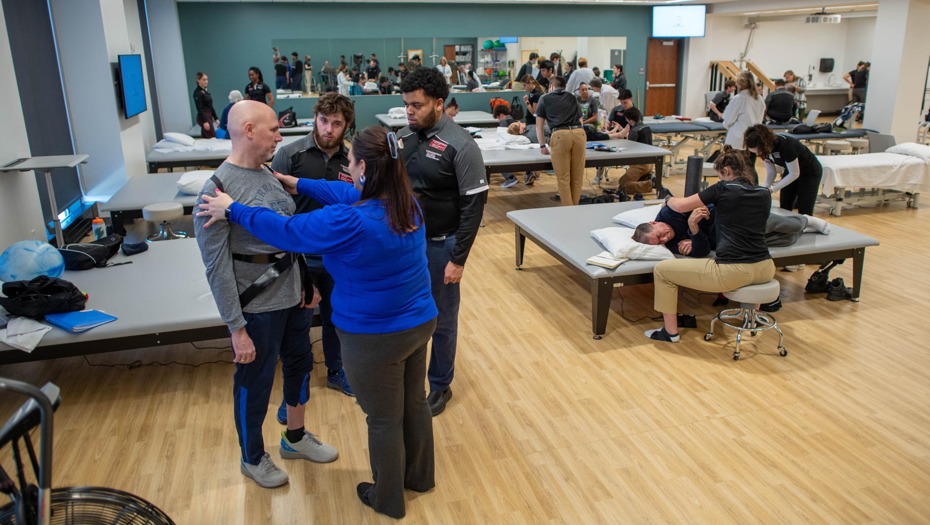 Physical therapy students work with community members during a Community Clinic in the Health Sciences Center at Springfield College on Tuesday, February 6, 2024
