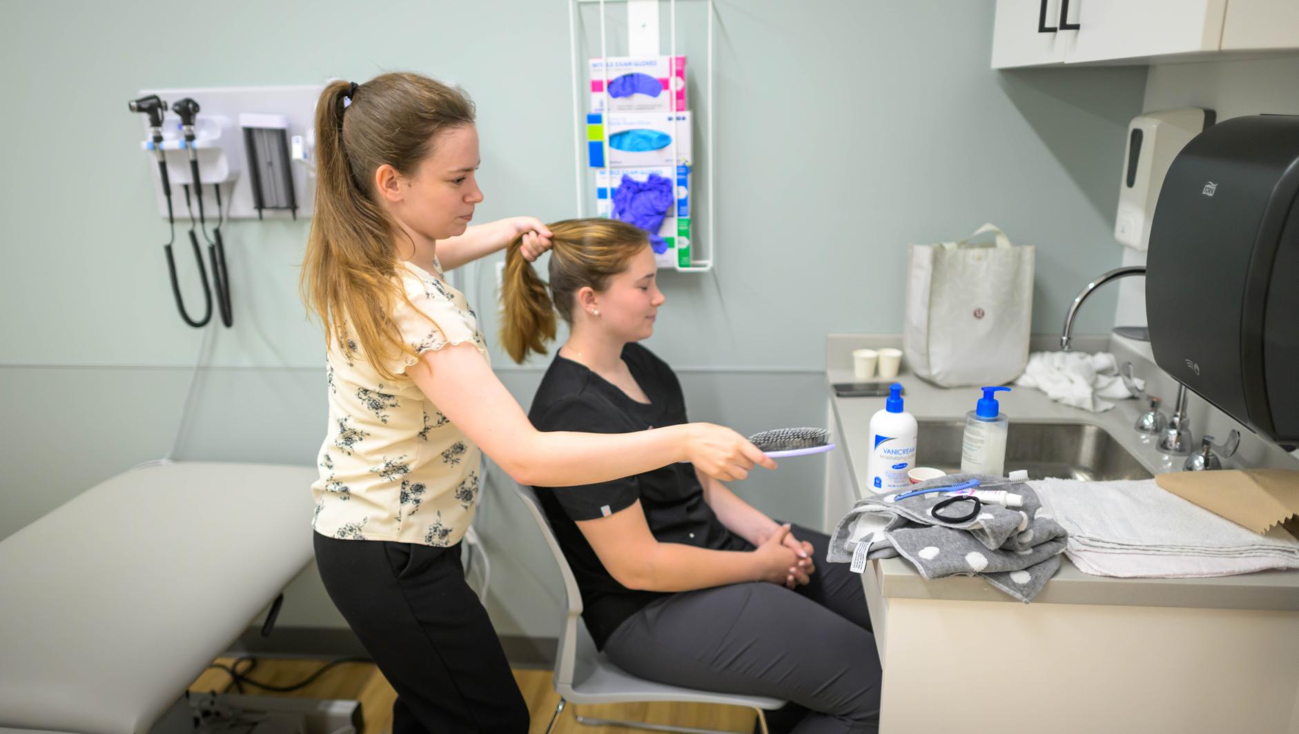 Springfield College Occupational Therapy students are encouraged to step outside their comfort zone as they are randomly paired with members of their cohort to practice providing clients with assistance to manage self care including bathing, dressing, toileting and grooming inside the Robotti Simulation Center on June 21, 2024.