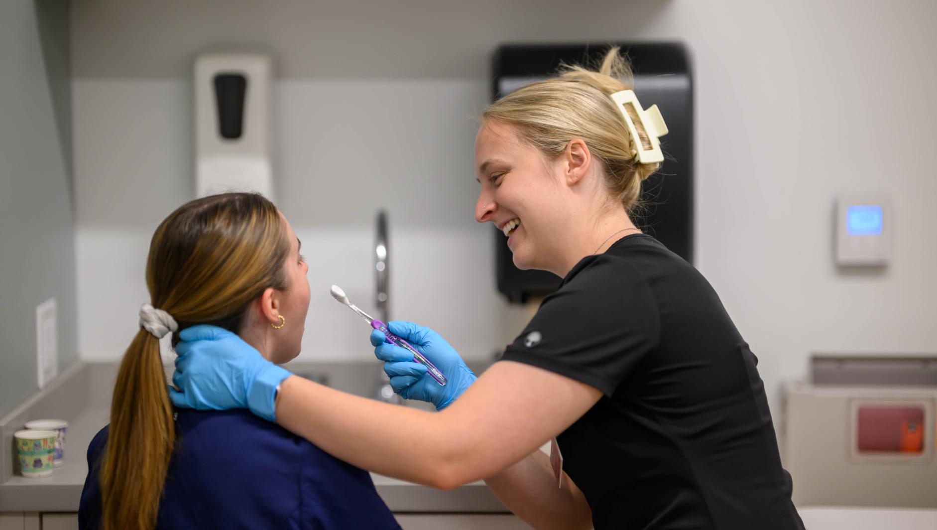 Springfield College Occupational Therapy students are encouraged to step outside their comfort zone as they are randomly paired with members of their cohort to practice providing clients with assistance to manage self care including bathing, dressing, toileting and grooming inside the Robotti Simulation Center on June 21, 2024.