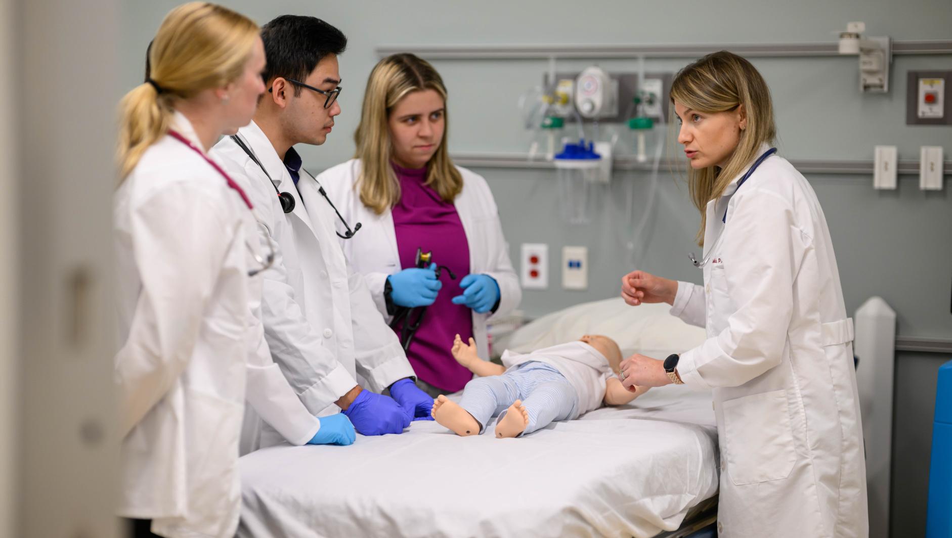 Springfield College Physician Assistant students work with realistic simulation mannequins inside the Robotti Simulation Center at the Health Sciences Center on June 25, 2024.