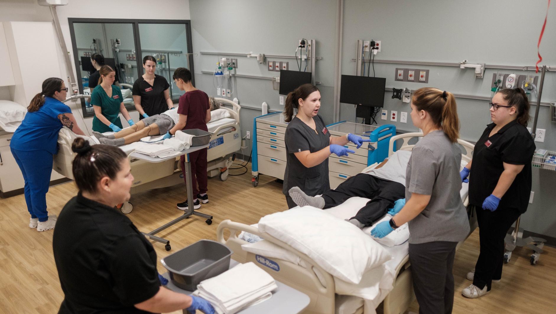 Springfield College Occupational Therapy students work with realistic simulation manikins to develop bed level care skills for dependent clients inside the Robotti Simulation Center at the Health Sciences Center on July 1, 2024.