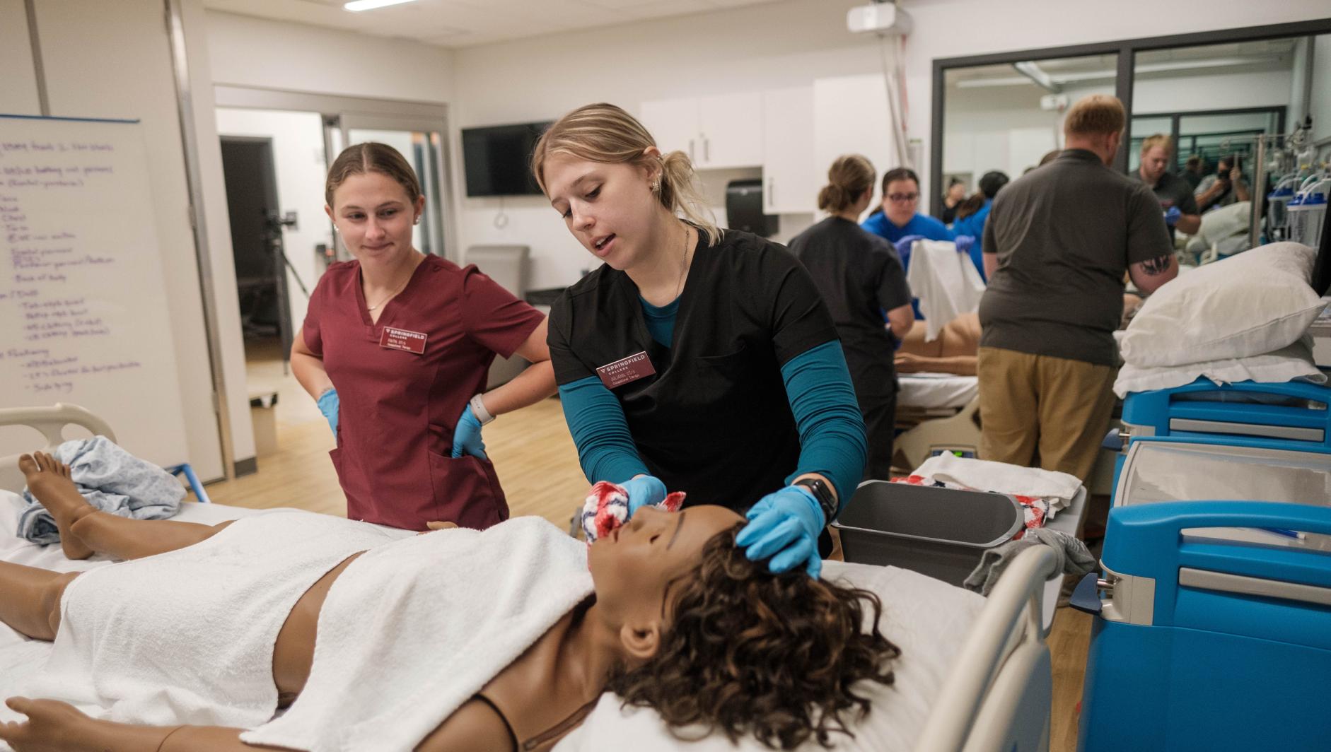 Springfield College Occupational Therapy students work with realistic simulation manikins to develop bed level care skills for dependent clients inside the Robotti Simulation Center at the Health Sciences Center on July 1, 2024.