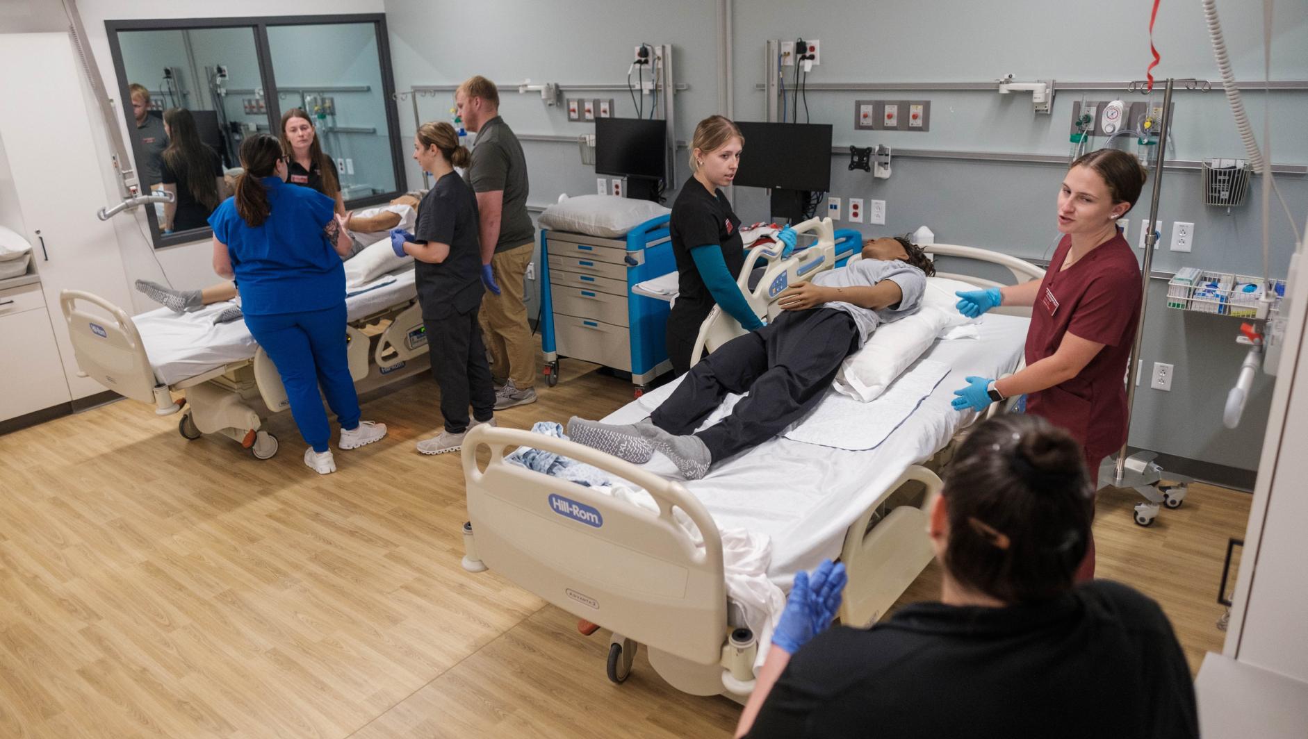 Springfield College Occupational Therapy students work with realistic simulation manikins to develop bed level care skills for dependent clients inside the Robotti Simulation Center at the Health Sciences Center on July 1, 2024.